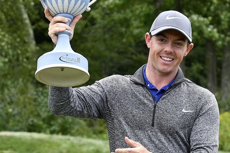 Rory McIlroy holds the trophy after winning the Deutsche Bank Championship. He overcame a bad start to go 19-under par over the last 69 holes.