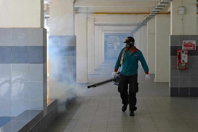 Thermal fogging being carried out in Sims Drive on Sunday. Singapore is in the midst of its traditional peak dengue season from June to October, and NEA said the Aedes aegypti mosquito population "remains high".