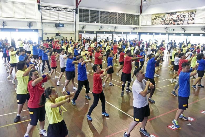 Students and staff of Fuchun Secondary performing a zumba routine for four hours to mark the school's 30th anniversary. 