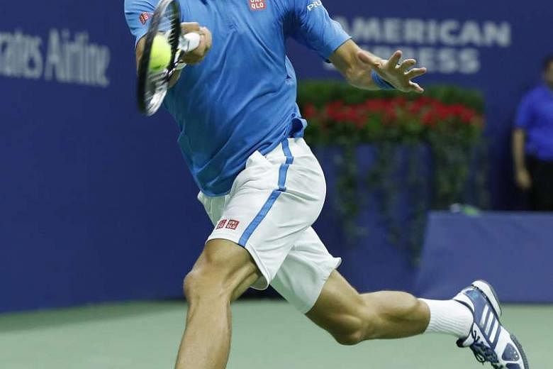 Novak Djokovic hits a running forehand against Jo-Wilfried Tsonga of France during their truncated quarter-final at Flushing Meadows on Tuesday. The Serb took the first two sets 6-3, 6-2 before the Frenchman retired after receiving on-court treatment for 