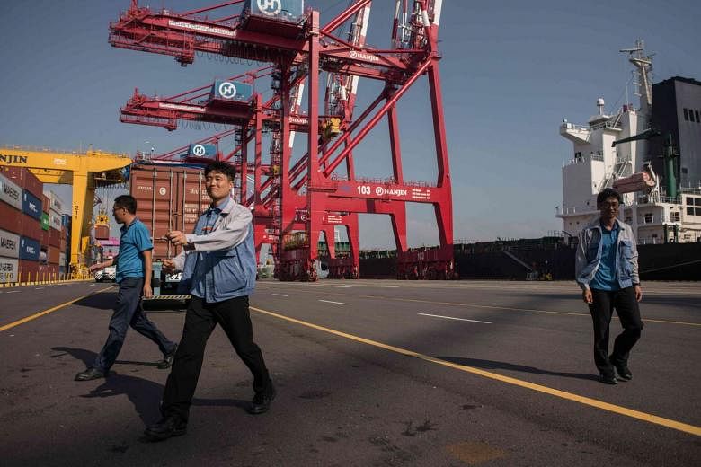 Workers at the Hanjin Incheon Container Terminal in the South Korean capital Seoul. Hanjin, one of the world's biggest shipping lines, filed for bankruptcy protection last week in Seoul. 
