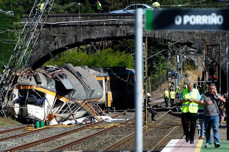 At least four people died and about 50 were injured yesterday when a train with at least 65 people on board went off the tracks in north-western Spain just as it was approaching a station while on its way to Portugal. The Portuguese driver was among 