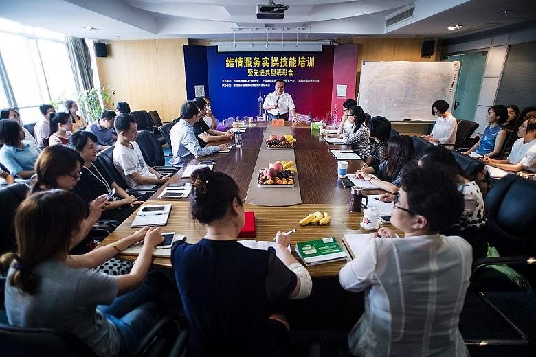 The founder of mistress-hunting firm Weiqing, Mr Shu Xin, holding a meeting at his Shanghai office. His firm's mistress hunters are mostly women and are all psychology, sociology or law graduates.