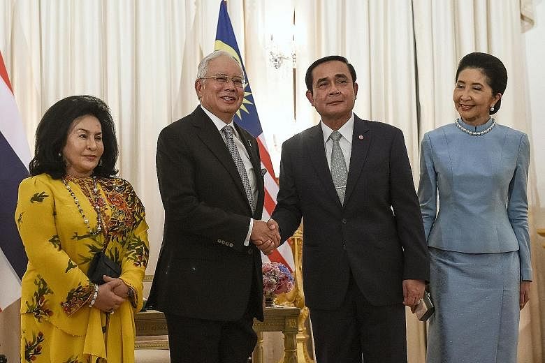 Malaysia's Mr Najib (second from left) and Thailand's Gen Prayut with their wives, Madam Rosmah Mansor (left) and Mrs Naraporn Chan-o-cha, at Government House in Bangkok yesterday.