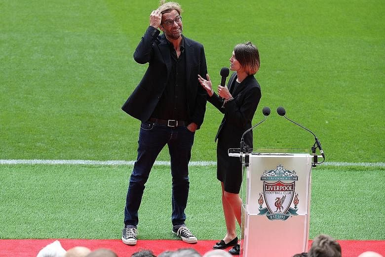 Liverpool manager Jurgen Klopp being interviewed by a club media official at the opening of Anfield's new Main Stand. The German said the presence of 8,000 more fans in the stadium will bring "more power" against Leicester today.