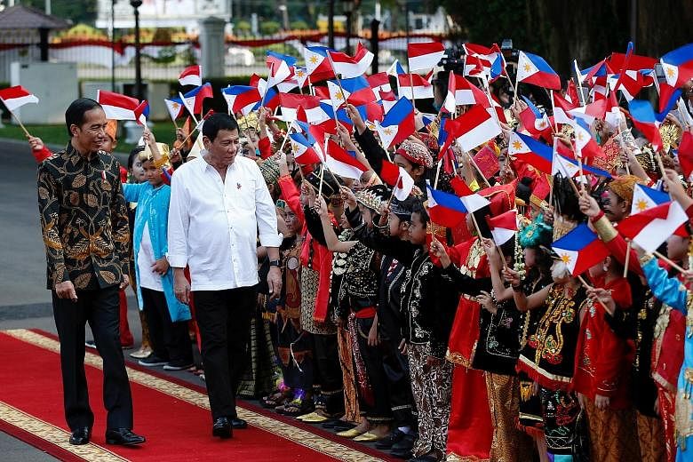 Mr Duterte (right) being welcomed to the presidential palace in Jakarta yesterday, with Mr Joko beside him. Mr Duterte said their discussion was "very productive" and he was pleased that Indonesia and the Philippines agreed to have more people-to-peo