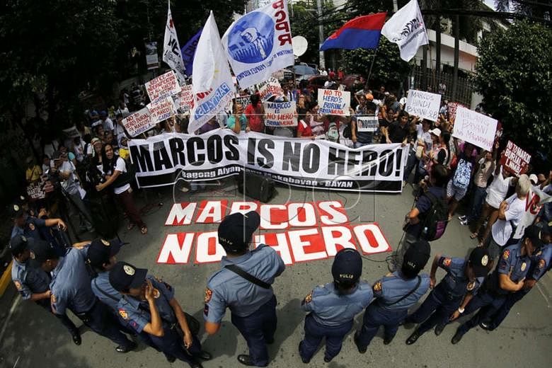 Protesters who oppose giving Marcos a hero's burial gathered last month outside the Supreme Court in Manila where petitions seeking to bar his interment at the Heroes' Cemetery were being heard. 