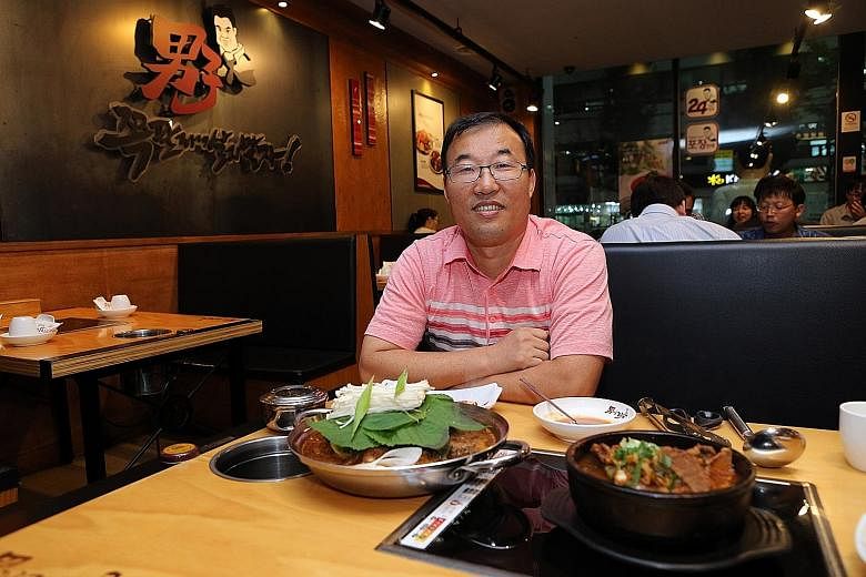 Ms Yoo Hyo Jin sometimes has gimbap (seaweed rice roll) when she lunches solo. Left: Namzatang restaurant owner Jang Sung Bae with a regular serving of spicy pork spine soup and a portion for one (in black pot). Above: Solo diners now make up 30 to 4