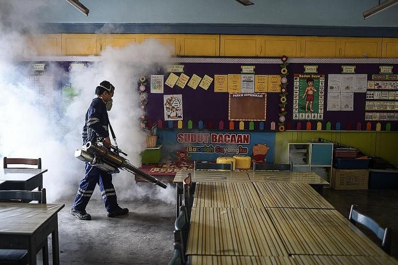 A worker fumigating a classroom in Kuala Lumpur last Sunday. On Sept 1, Malaysia reported its first Zika case - a woman who had visited Singapore.