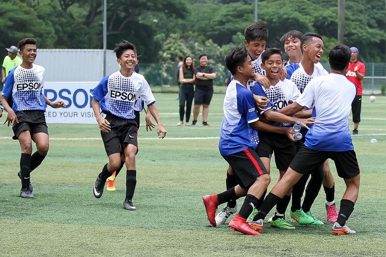 Players from Valentia CF celebrate their penalty shootout victory that won them the inaugural Epson Singapore Cup.