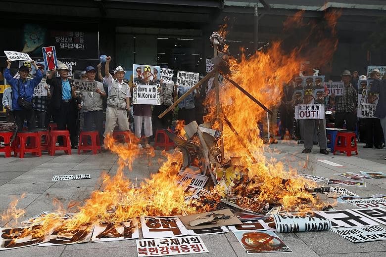 Activists burning an effigy of North Korean leader Kim Jong Un during a rally in Seoul yesterday against the North's fifth nuclear test. South Korea said the nuclear threat from the North is growing and called for tough new sanctions from the UN Secu