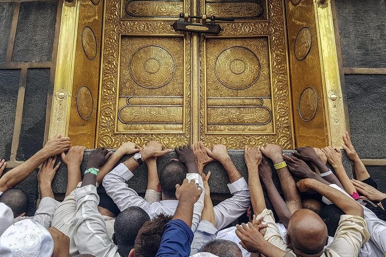 Muslim pilgrims at the door of the Kaaba, Islam's holiest shrine, in Mecca last Friday. The Saudi authorities say they have put in "great efforts" to ensure pilgrims' safety.