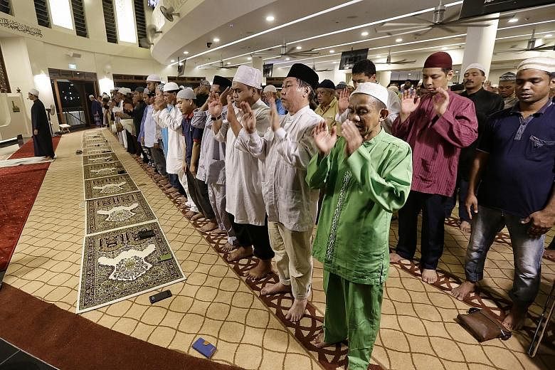 Muslims marking today's Hari Raya Haji festival by praying yesterday evening at Singapore's newest mosque, Maarof Mosque, which opened last month in Jurong West. They also recited the takbir in celebration of the festival. The takbir proclaims the gr