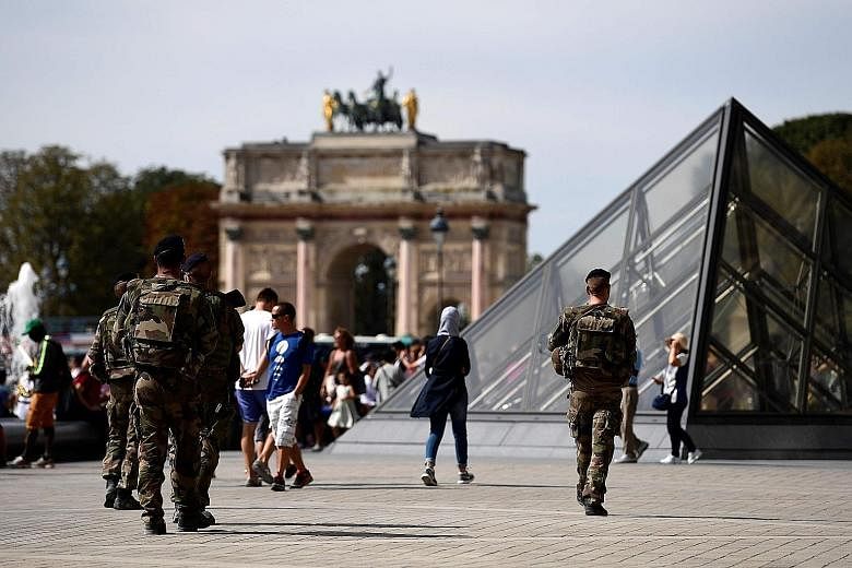 Soldiers on patrol at the Louvre Museum in Paris last Saturday. Several women were detained last week on suspicion of planning attacks in France, a country on high alert after a string of terrorist assaults in the past 18 months.