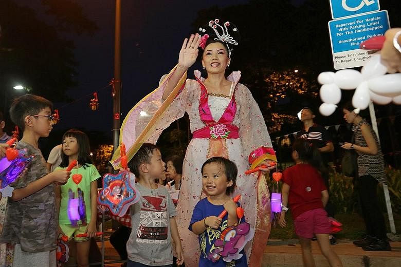 Children yesterday getting ready for a lantern walk at Joo Chiat's Mid-Autumn Festival celebration, which ESM Goh attended.