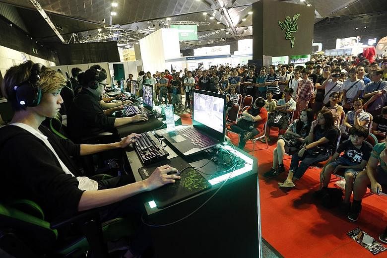 Gamers battling it out at the inaugural Singapore E- Sports League, the highlight at Comex. More than 30 teams competed in four tournaments over four days for more than $20,000 worth of gaming products.