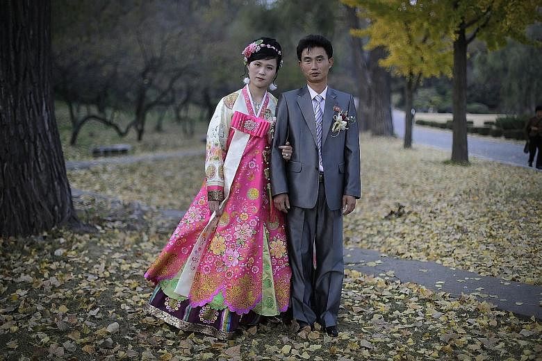 A bride and groom posing for a wedding photograph at Moranbong hill in 2014.