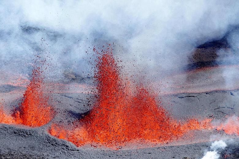 Molten lava spewing from the volcano Piton de la Fournaise, literally Peak of the Furnace, on the eastern side of France's Reunion Island in the Indian Ocean on Sunday. The peak is one of the world's most active volcanoes and has seen more than 150 e