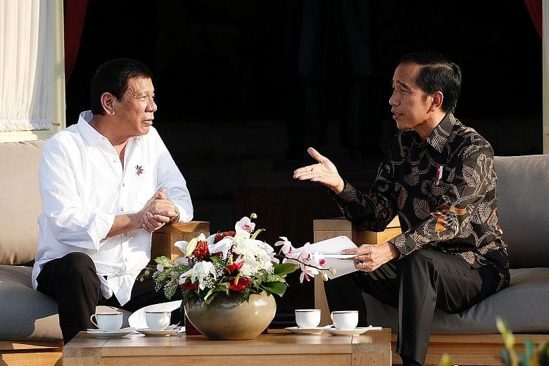 Left: Philippine President Rodrigo Duterte (far left) with Indonesian President Joko Widodo at the presidential palace in Jakarta on Friday. Mr Joko told reporters that Mr Duterte had told him to go ahead with the execution of Filipino death row pris
