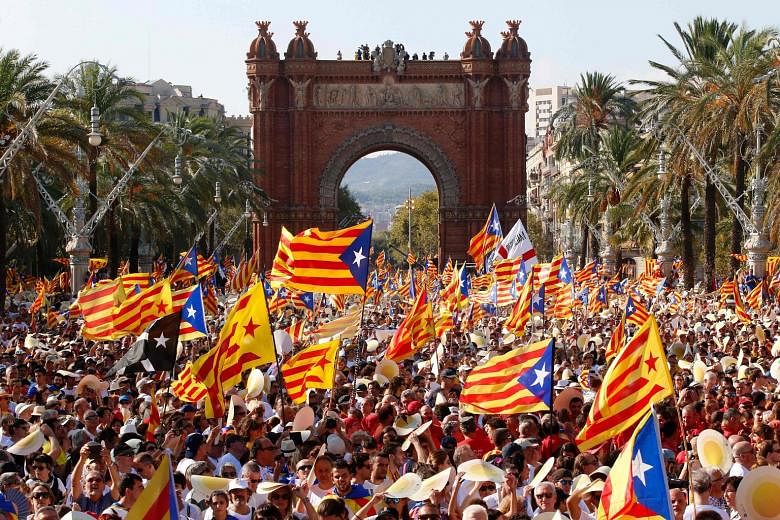 Crowds waving pro-independence Catalan flags during a demonstration in Barcelona on Sunday, which is the region's national day known as "Diada".