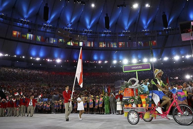 Badminton player Derek Wong carrying the national flag and leading the Singapore contingent during the opening ceremony of the Rio Olympics in Brazil last month.