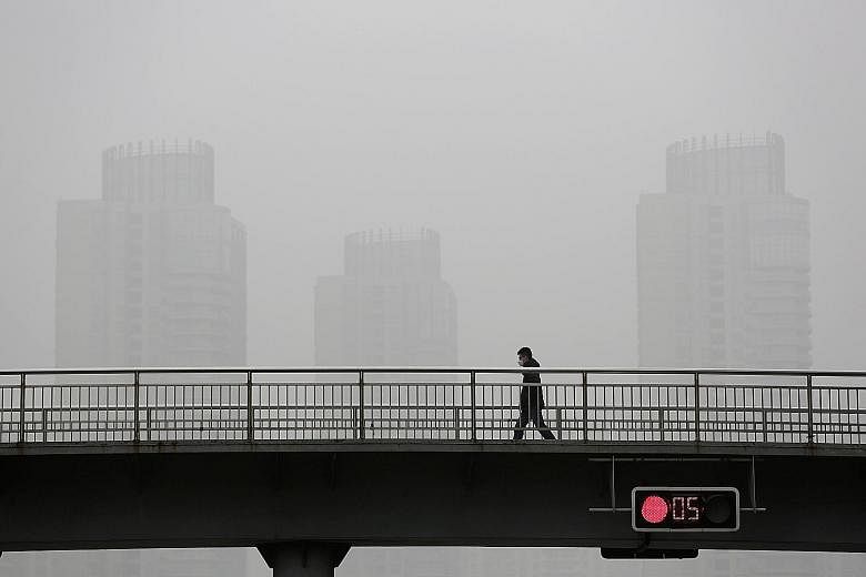 Heavy smog in Shanghai. Mr Lee thinks his cancer might have been triggered by his frequent work trips to China, where air pollution is a major problem in some cities, and where he was often surrounded by heavy smokers.