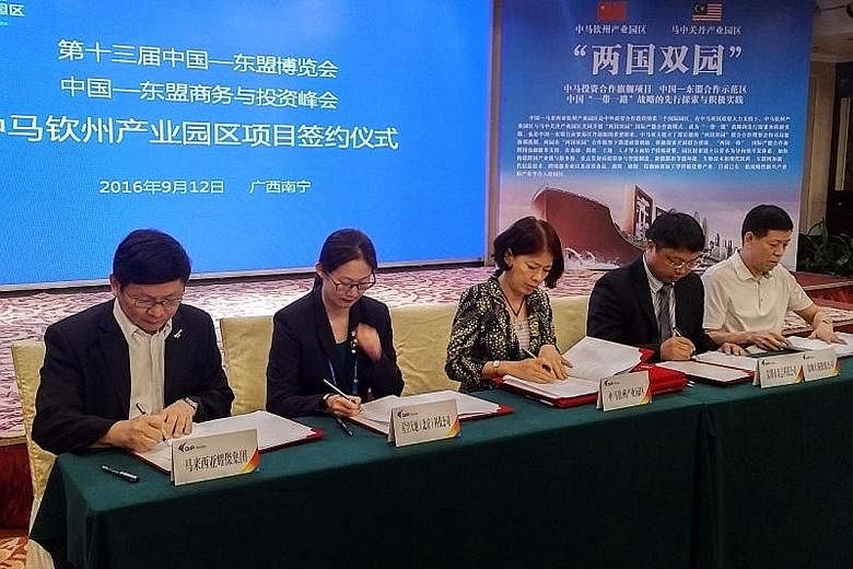 Mr Dominic Su (left), CEO of Sarawak-based Regal International Group, signing an agreement with the China-Malaysia Qinzhou Industrial Park Administrative Committee on Monday, which gives his company sole rights to develop a halal industry zone within