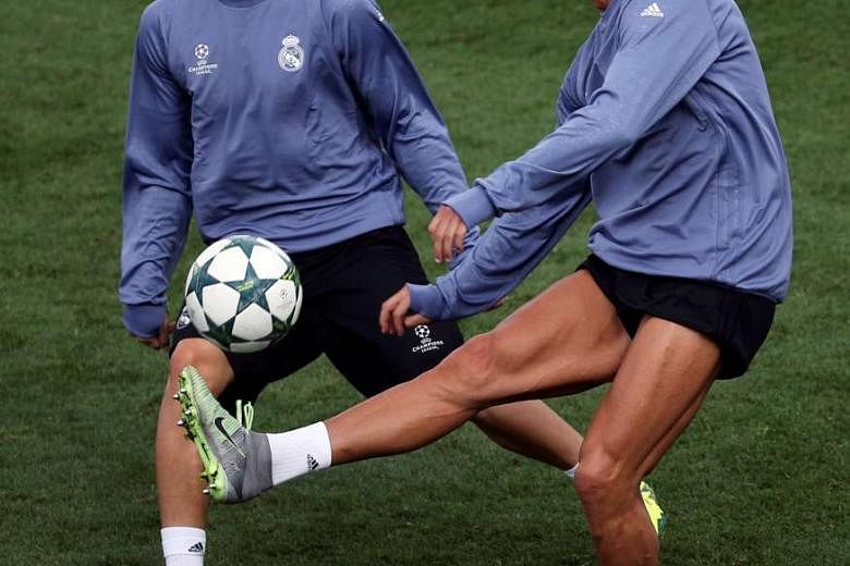 Real Madrid forward Cristiano Ronaldo, 31, training with midfielder Mateo Kovacic ahead of their Champions League opener against Sporting Lisbon. The Portugal captain scored in victories over Sporting while he was with Manchester United. He joined the Por