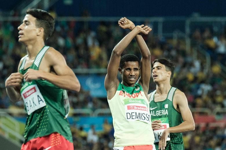 Ethiopia's Tamiru Demisse, silver medallist in the men's T13 1,500m, crosses his arms in a symbol of defiance against the country's government.