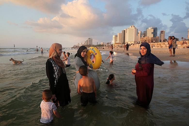 Palestinian women having a good time on the beach in Tel Aviv during the Eid al-Adha holiday on Tuesday. Thousands of Palestinians from the West Bank swam at beaches in and around the Israeli commercial capital Tel Aviv, after being granted permits t
