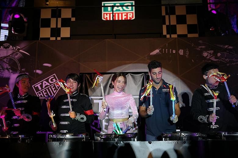 Above: Red Bull driver Daniel Ricciardo preparing to test the Ricciardo N35-RS kart at the KF1 Karting Circuit, where his own kart brand was launched. Ricciardo and singer-songwriter G.E.M. at a TAG Heuer event yesterday, playing drums together follo