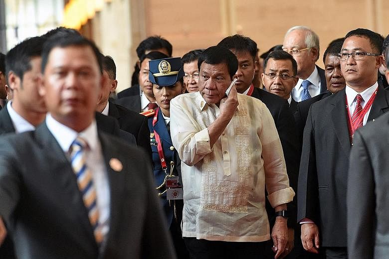 Mr Rodrigo Duterte (above centre) on his way to the closing ceremony for the Asean Summit in Vientiane last Thursday. Mr Barack Obama (below) leaving after the closing ceremony. The three-day summit was Mr Duterte's first Asean outing, but the impression 
