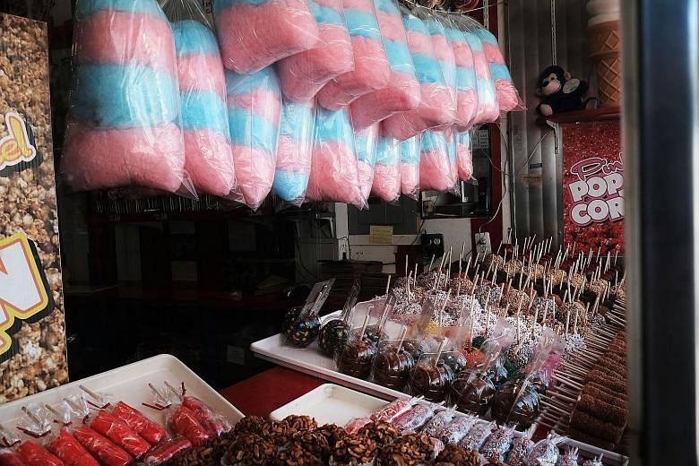 Cotton candy and other treats enjoyed by holidaymakers in New York City. Newly released papers show that the Sugar Research Foundation - today's Sugar Association - paid scientists to minimise the link between sugar and heart health and shift the bla