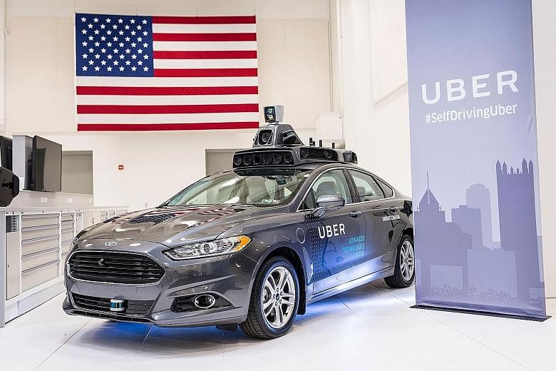 Four of the Ford Fusion hybrids, with their ungainly rooftop load of technology, were to be deployed yesterday on the challenging roads of Pittsburgh, Pennsylvania, steering themselves to pick up regular Uber passengers. Uber has at least a dozen mor