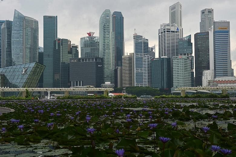 Skyline of Singapore's central business district (above). According to Ms Alice Tan of Knight Frank Singapore, the high influx of about six million sq ft gross floor area of office space island-wide for this year and next year will weigh on rentals i