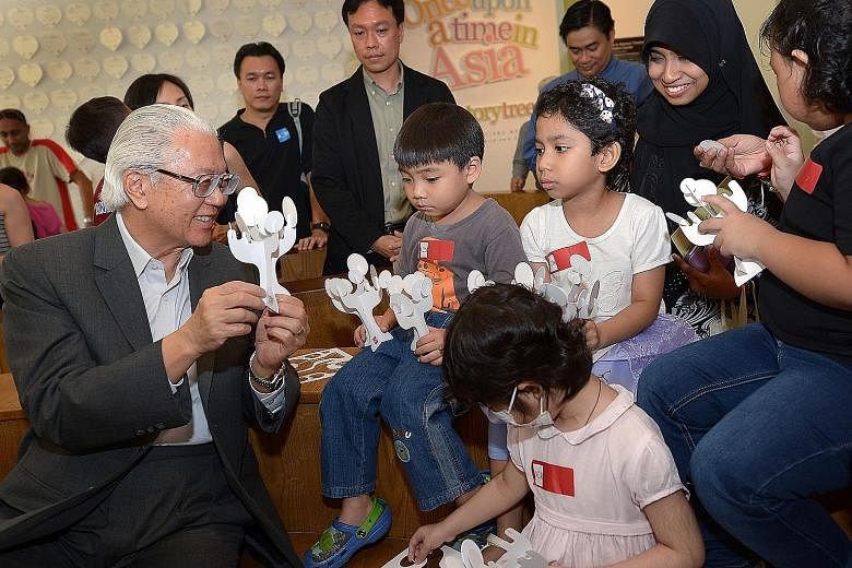 President Tony Tan Keng Yam interacting with children at a 2014 exhibition. Every Singaporean has to be able to identify with the president, said the Government.