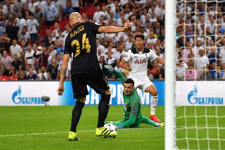 Tottenham striker Son Heung Min (right) beats Monaco goalkeeper Danijel Subasic but Andrea Raggi clears off the line during the Champions League group E match. The French league leaders won 2-1, leaving Spurs on one win at the new Wembley in six appe