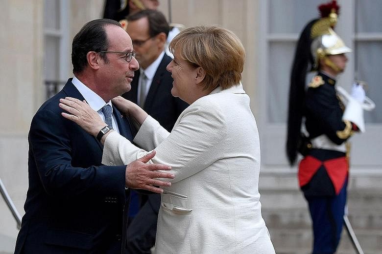 Mr Hollande welcoming Dr Merkel for a working meeting at the Elysee Palace in Paris yesterday, ahead of the meeting of the heads of state and government of EU member states in Bratislava today.