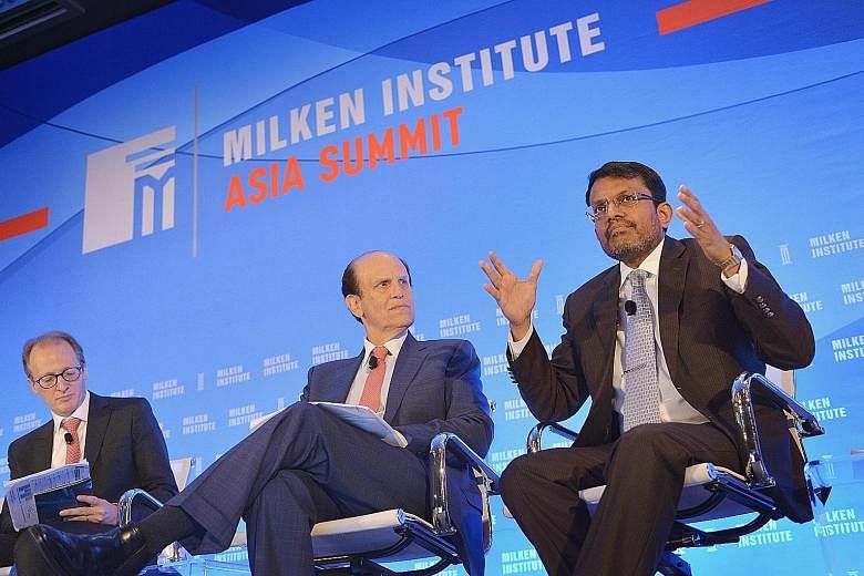 From left: Moderator Jonathan Woetzel, director of McKinsey Global Institute and senior partner, Shanghai, McKinsey & Co; chairman of Milken Institute Michael Milken; and Mr Menon at the Milken Institute Asia Summit 2016 yesterday.