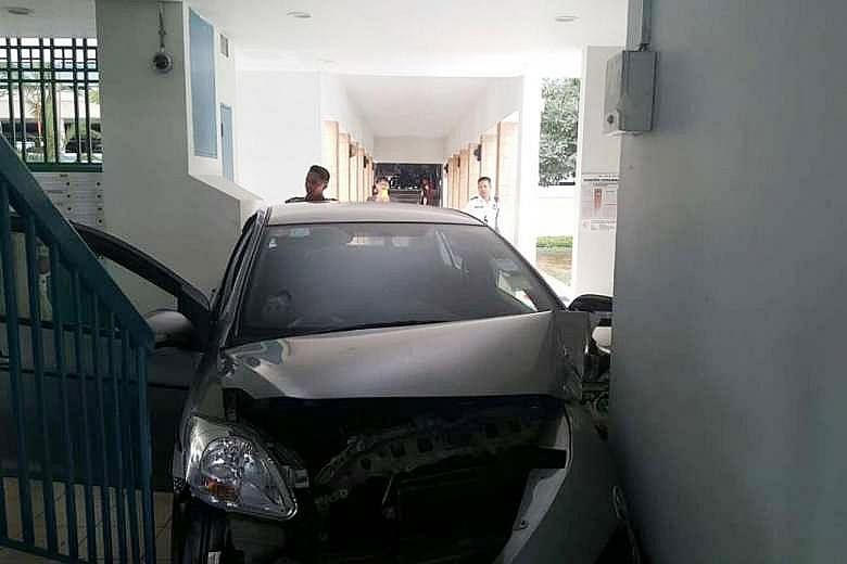 A car crashed into the void deck of a Housing Board block in Woodlands yesterday afternoon. The silver sedan was wedged between a stairwell and a wall in front of the lift lobby at Block 791, Woodlands Avenue 6. The Singapore Civil Defence Force (SCD