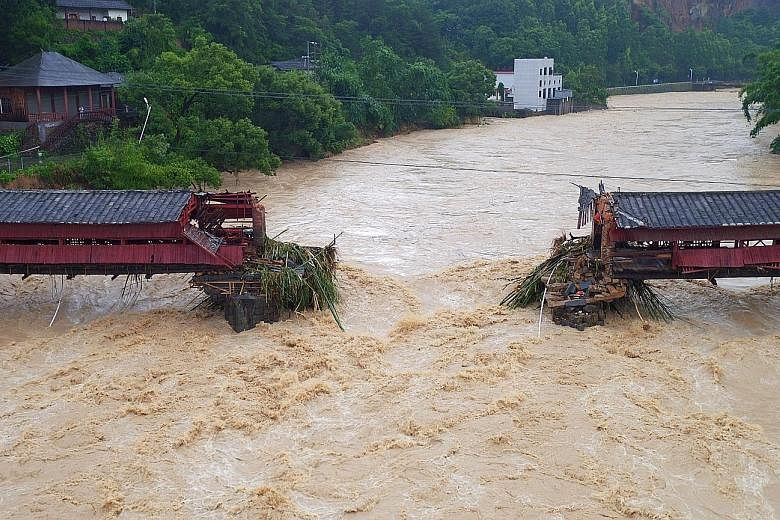 Part of an ancient bridge in Yongchun, Fujian province, was swept away as Typhoon Meranti made landfall in south-east China on Thursday. Some 1.65 million households are without power in the province.
