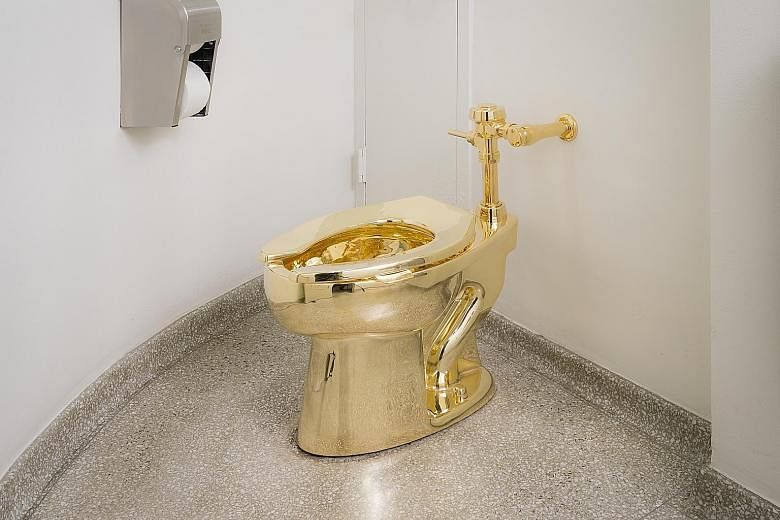 Italian artist Maurizio Cattelan's solid 18K-gold copy of a Kohler toilet in a restroom of the Solomon R. Guggenheim Museum.
