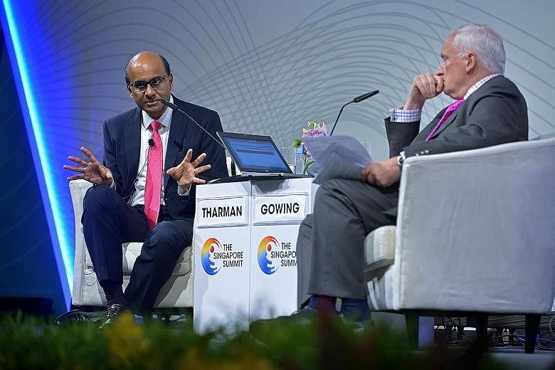 Deputy Prime Minister Tharman Shanmugaratnam with moderator Nik Gowing at a dialogue at the Singapore Summit yesterday. The jobs of governments and educators are more difficult as change is happening far more frequently, Mr Tharman said. This means i