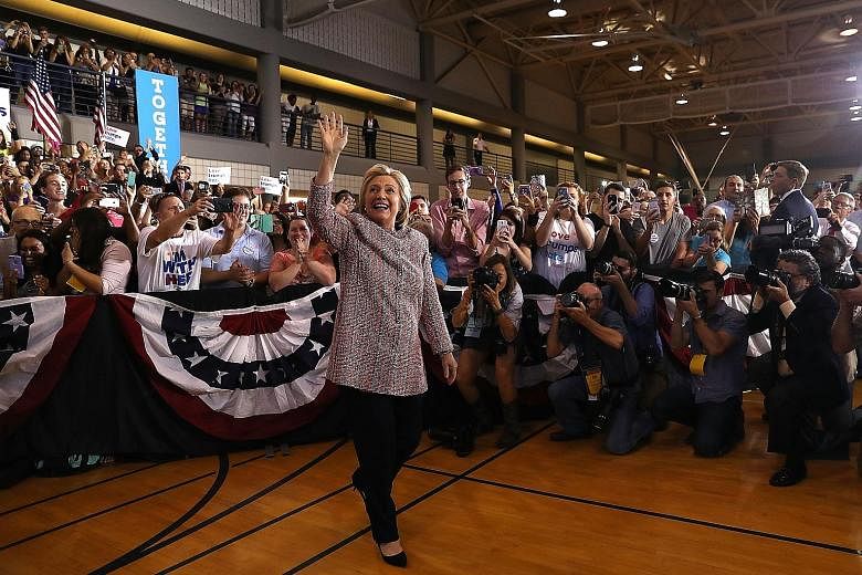 Mrs Clinton at her rally in Greensboro, North Carolina, where she sought to refocus her campaign on the plight of the working class, which has been a potent theme for Republican rival Donald Trump.