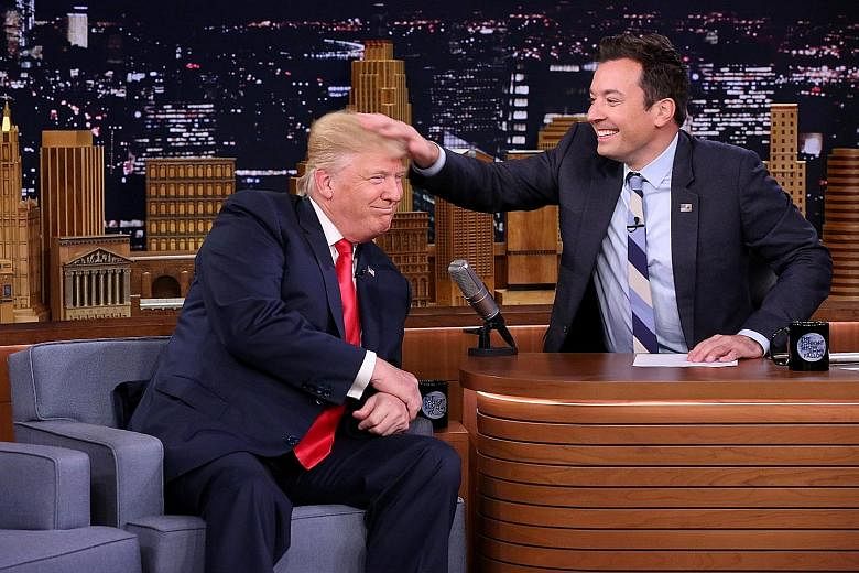 Mr Trump grinning as Fallon messed up his hair with a vigorous rub, causing his long locks to point messily every which way.