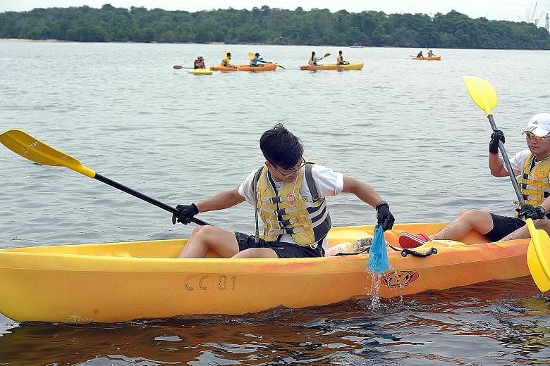 Volunteers, including secondary school students, on kayaks doing their part to clear garbage from Singapore's waters yesterday as part of International Coastal Cleanup Day. During a three-hour trip from Sembawang Beach to Seletar Island, the group co