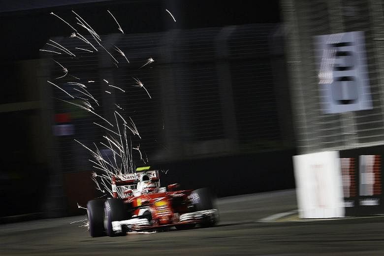 Left: Sparks flying as Ferrari driver Kimi Raikkonen approaches Turn 16 during the qualifying session at the Marina Bay Street Circuit yesterday evening. He qualified for tonight's main race in fifth place. Below: A huge monitor lizard lumbering acro