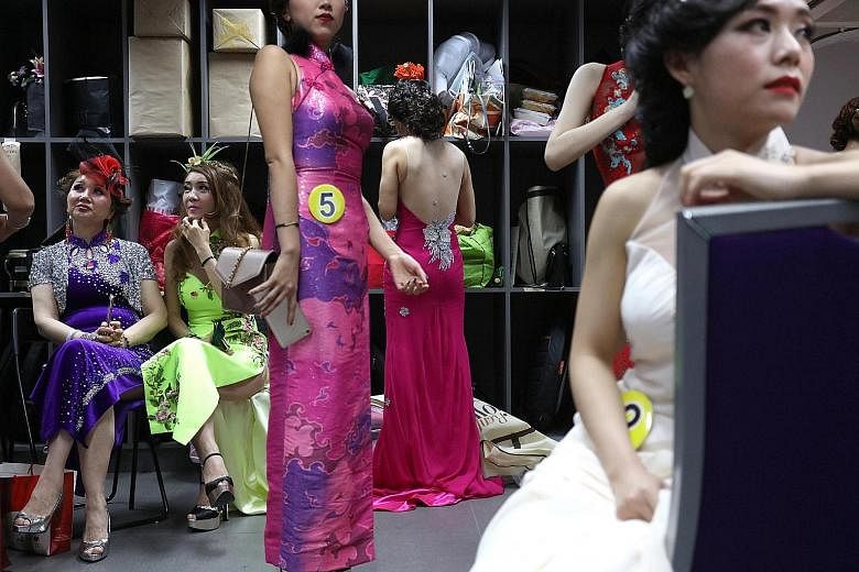 Contestants dressed in cheongsams - and one in a sari - posing for a photo before the start of the finals of the Singapore Qipao Society's inaugural pageant at the Axis Theatre at Textile Centre on Friday night. Established last year, the society aim