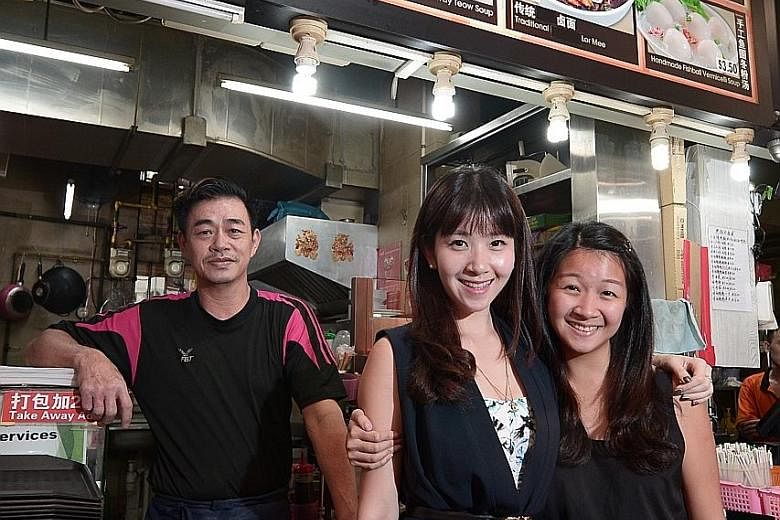 Ms Teo (centre) at her 55-year-old father Teo Chye Huat's noodle stall with her younger sister Eileen, 23. During her teenage years, Ms Teo struggled with financial worries, including her father's bankruptcy. Now the award-winning wealth planner help
