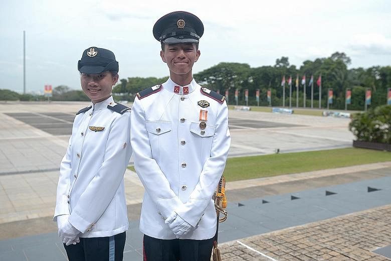 With Second- Lieutenant Brandon Tan Kah Hwee at the Safti Military Institute commissioning parade in Jurong yesterday is 2LT Lee Man Ying, the only woman in her graduating cohort.